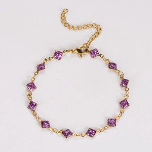 Detail of gold-plated bracelet featuring purple glitter square charms and adjustable chain