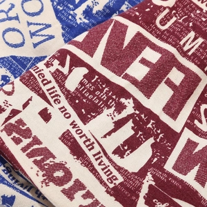 Detailed macro view of retro letter print on vintage beige cotton slouchy beanie
