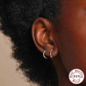 Sparkling S925 sterling silver gold hoop earrings with pavé zircon stones on a model