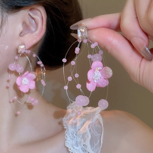 Detail of pink fabric flower earrings with beaded tassels and clear zircon stud