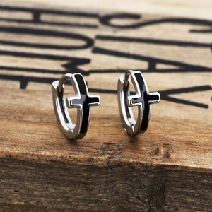 Minimalist vintage cross dangle earrings in silver and black on textured wood