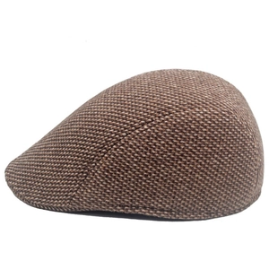 Close-up of thick textured tweed fabric and side profile of the wool ivy flat cap