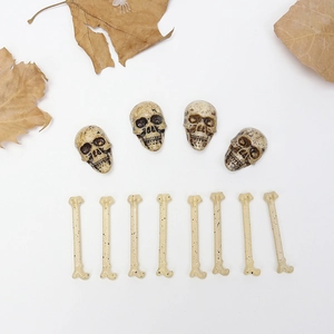 Miniature Halloween skull and bone props with vintage texture on white background