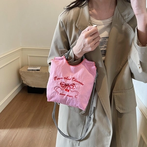 Pink nylon handbag with bow and cherry embroidery featuring checkered woven straps