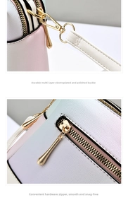 Detail of gradient leather handbag with polished gold-plated buckle and textured zipper pull