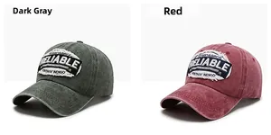 Detail of vintage washed baseball caps in dark grey and red with embroidered patches