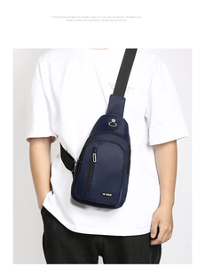 Detail of navy blue waterproof Oxford cloth chest bag with zipper pockets and headphone port