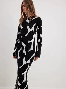 Slim fit black and white knit long sleeve maxi dress with abstract pattern and high collar