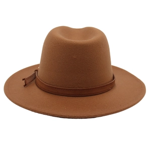 Detail view of camel felt fedora hat featuring a dark brown leather decorative belt