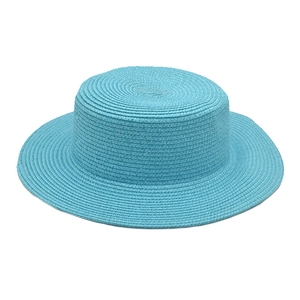 Detail of sky blue woven straw boater hat showing fine texture and flat top design