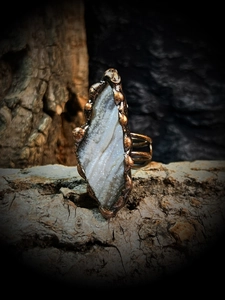 Détail d'une bague en agate solaire brute avec monture en bronze faite à la main