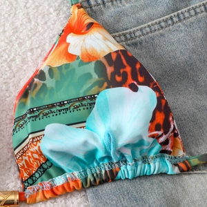 Detail of floral and leopard print bikini top with ruffled edges and gold metal accents