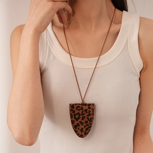Minimalist leopard print faux leather shield pendant necklace with thin brown cord strap