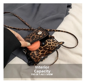 Mini leopard print crossbody bag showing internal space for lipstick and powder