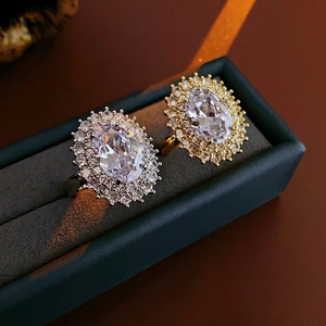 Luxurious gold and silver plated oval halo rings with zircons in a velvet box