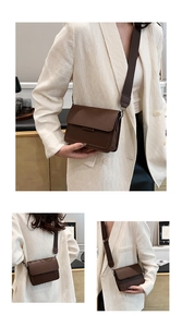 Detail of a vintage dark brown crossbody bag featuring a wide adjustable shoulder strap