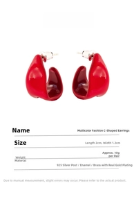 Detail of red enamel C-shaped earrings with 925 silver needles and gold plated brass