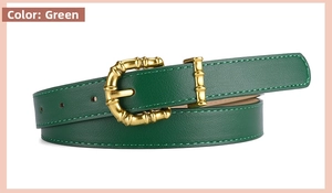 Detail of green leather belt featuring a vintage gold bamboo-style buckle and loop