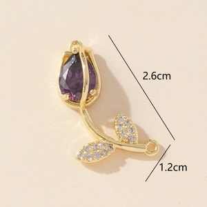 Detailed view of a gold tulip pendant with purple gemstone showing 2.6cm x 1.2cm dimensions