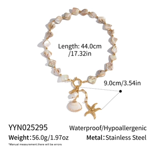 Detail of ocean-themed necklace with shell, starfish pendant and stainless steel beads
