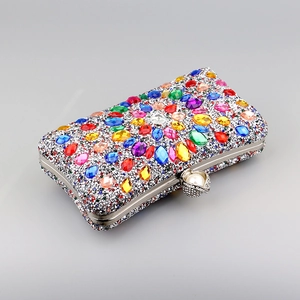 Detailed close-up of a colorful rhinestone evening clutch with pearl metal clasp
