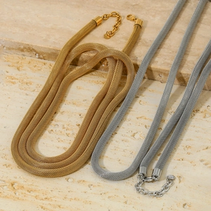 Minimalist wide mesh chain necklaces in gold and silver finish on marble display