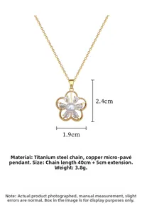 Detail view of titanium steel necklace with gold flower pendant and white pearl inlay