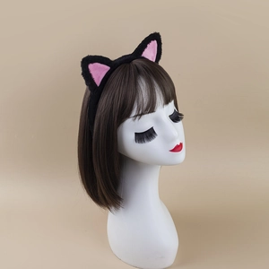 Plush black cat ear headband with pink inner lining on a model for hair styling