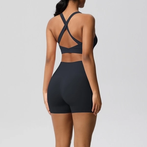 Detail of cross-back yoga bra and high-waisted lifting shorts in black athletic set
