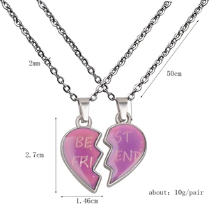 Close-up of color-changing heart pendant necklaces for best friends on steel chains