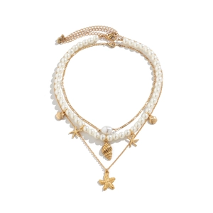 Three-layer ocean style necklace with white faux pearls, gold sea stars and conch shells