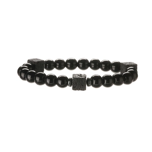 Detail of black obsidian beads and textured lava stone squares on a beaded bracelet
