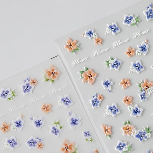 3D floral relief nail art stickers with blue and purple flowers in minimalist style