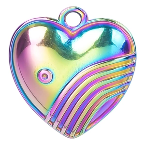 Macro detail of rainbow plated stainless steel heart pendant with textured wave pattern