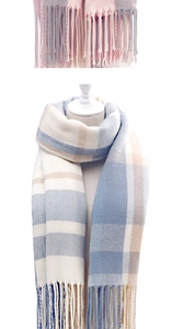 Close-up of soft plaid winter scarf with pink and blue tassels on a white mannequin