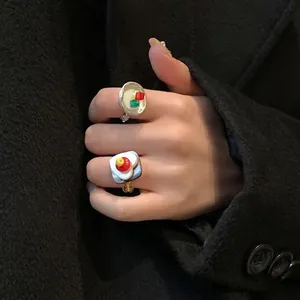 Retro multi-element beaded rings with silver finish and red drip glaze on black background