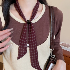 Detail of vintage burgundy plaid skinny silk scarf necklace with high-quality fabric texture