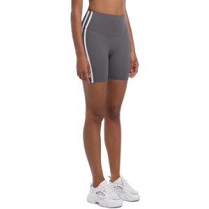 Detail of high waist yoga shorts with side stripes and slim fit design on female model