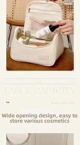 Close-up of cream woven travel vanity case with inner mesh pocket and wide opening