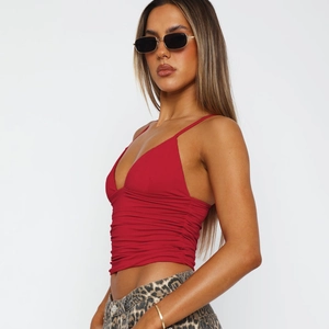 Detail shot of red V-neck camisole with ruched fabric and slim fit design