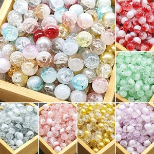 Mixed color 10mm cracked glass beads for jewelry making displayed in a wooden box