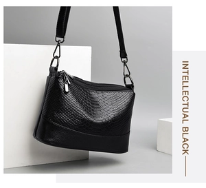 Close-up of black crocodile pattern PU leather bag with adjustable strap and metal hardware