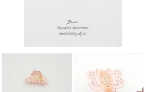 Macro detail of pink acetate hair claw clip featuring heart shape and glittery rhinestones