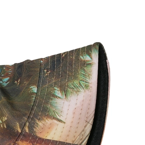 Close-up of tropical palm leaf print on sun hat brim with reinforced stitching details