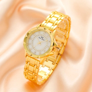 Elegant gold quartz watch for women with diamond accents on a white silk background