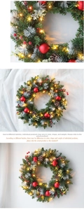 Close-up of Christmas wreath with red berries, pine cones and warm LED lights decor