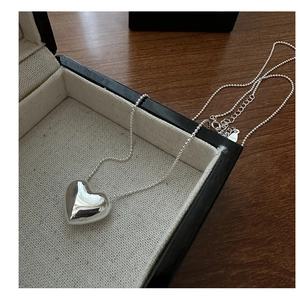 Close-up of S925 sterling silver heart pendant necklace on beaded chain detail