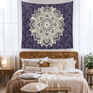 Detailed view of a purple mandala tapestry with white paisley patterns in a boho bedroom