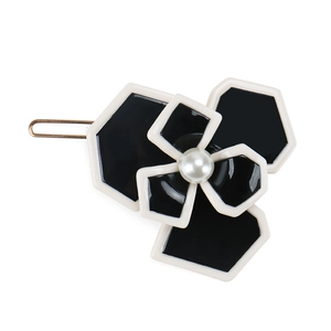 Elegant black and white camellia hair clip with pearl center and golden metal base