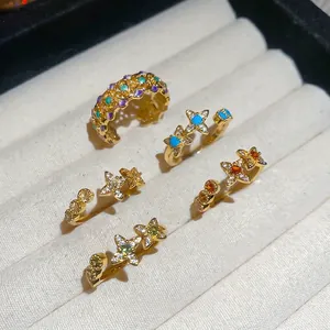 18k gold plated floral star open rings set with colorful zircons on beige velvet